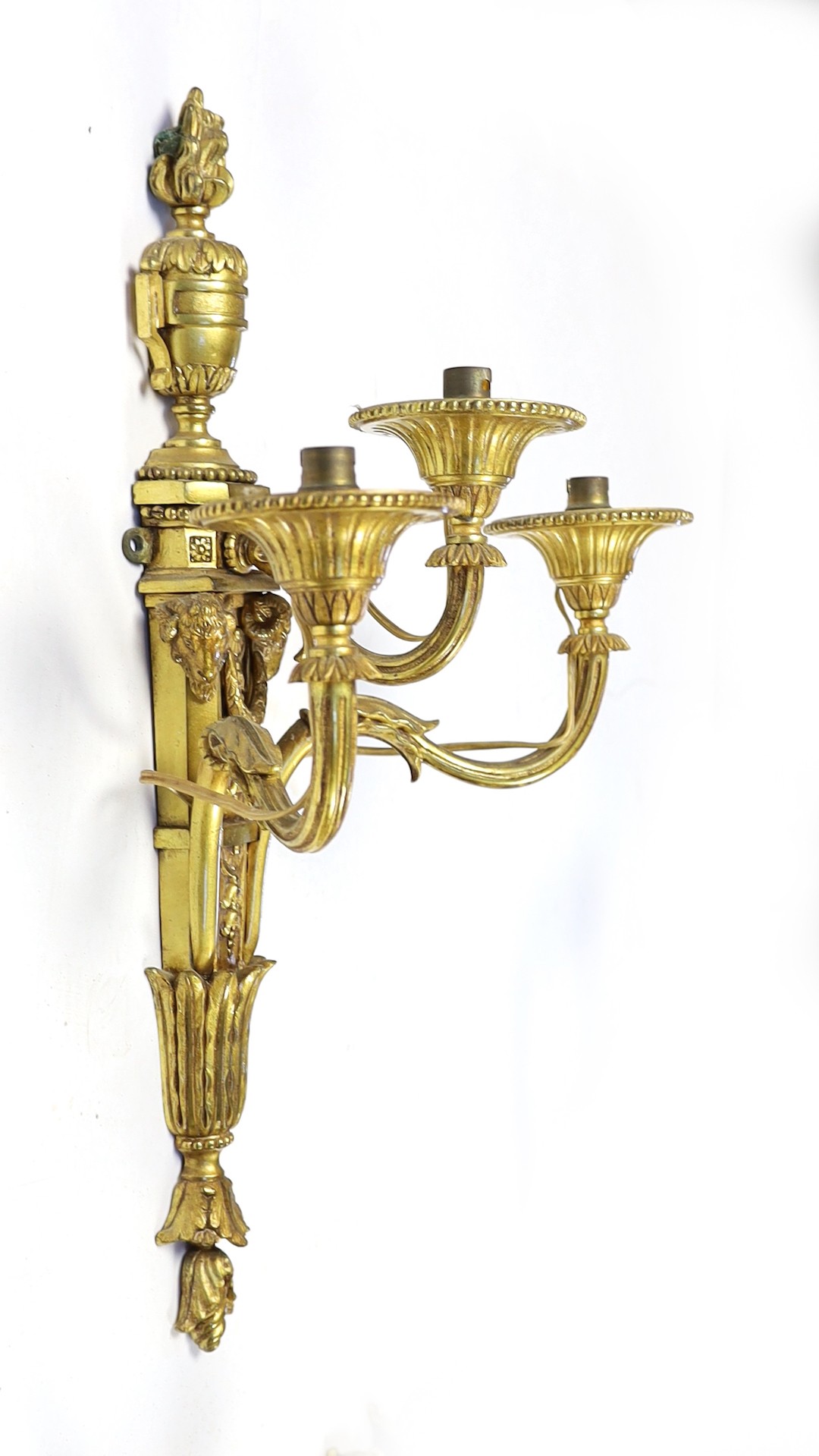 A set of eight cast gilt brass three branch wall sconces Height 23cm Width 22cm